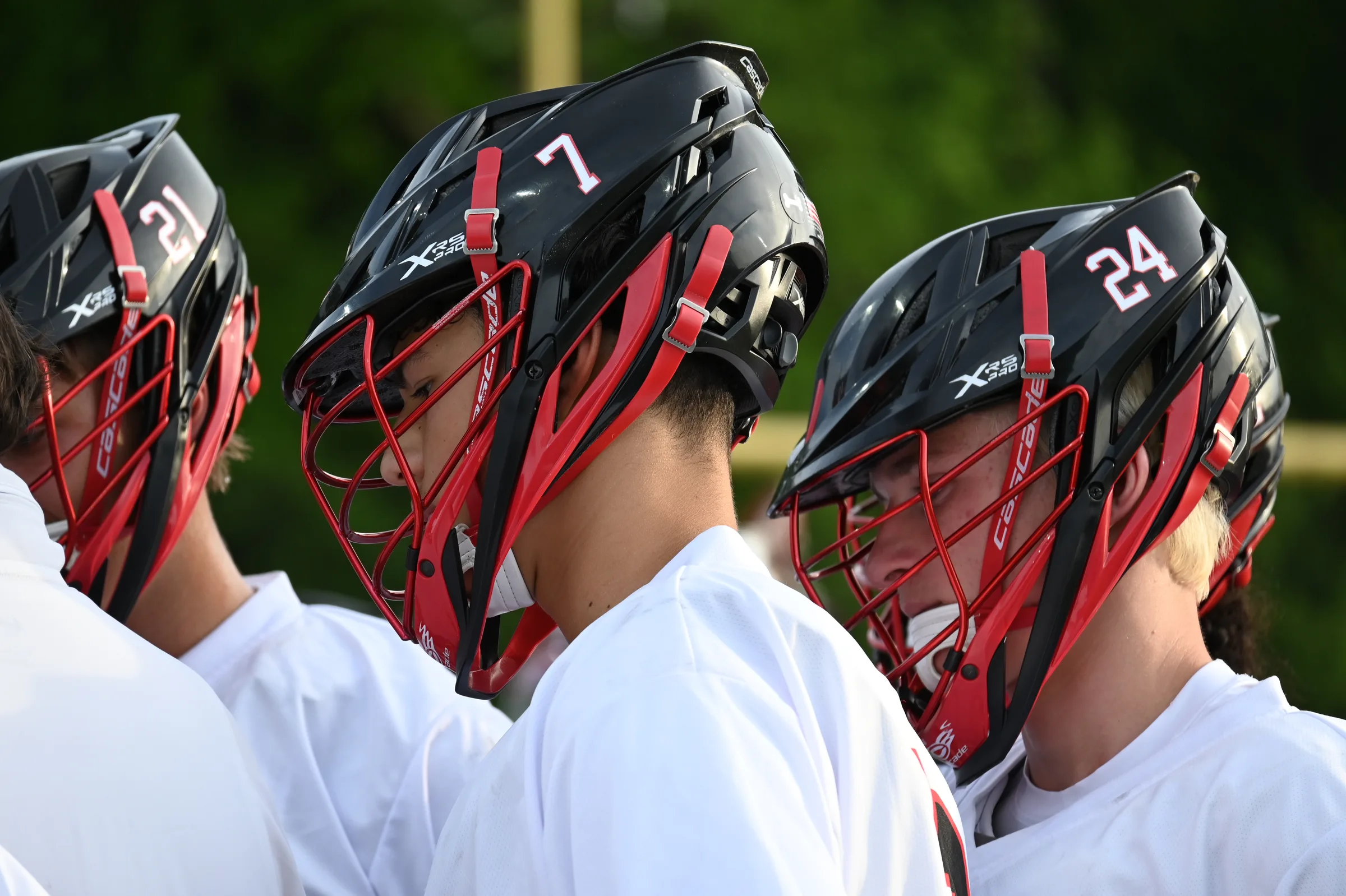 Boys lacrosse players lined up in North Gwinnett helmets