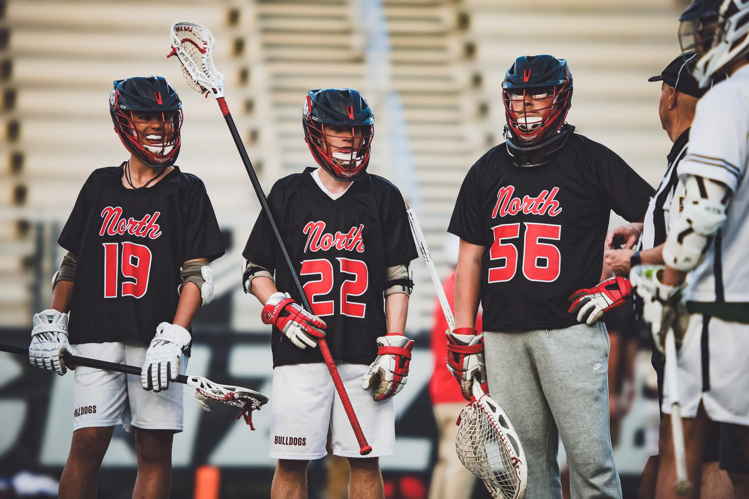 North Gwinnett boys lacrosse players on the sideline