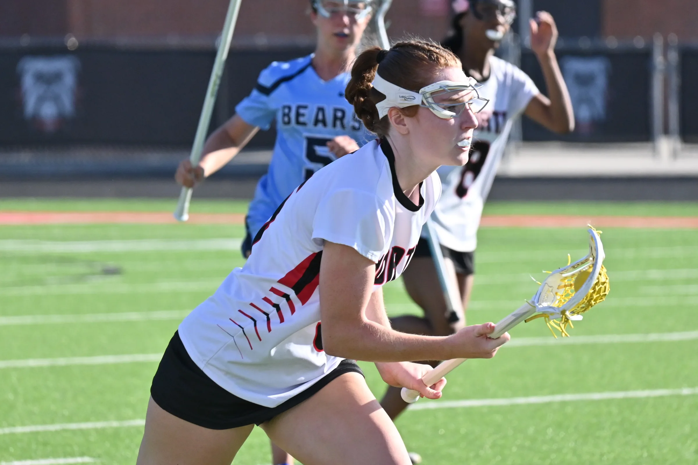 Girls lacrosse player ready with the ball at North Gwinnett